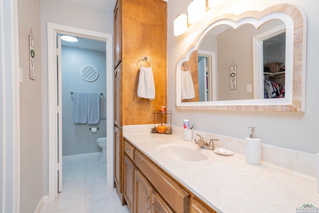 bathroom featuring vanity, toilet, and tile patterned flooring