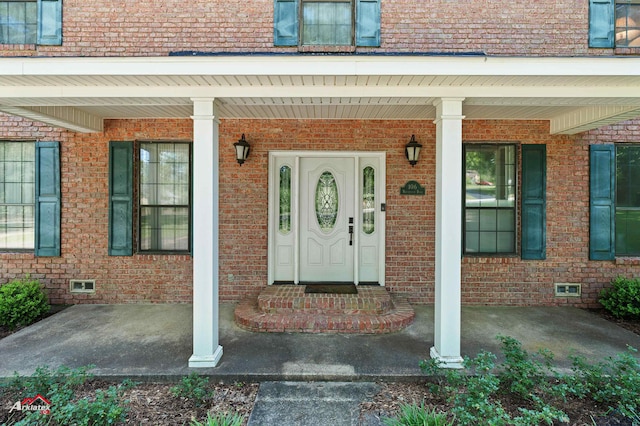 106 Brachfield Rd, Henderson, TX 75654 - view of exterior entry featuring crawl space, covered porch, and brick siding