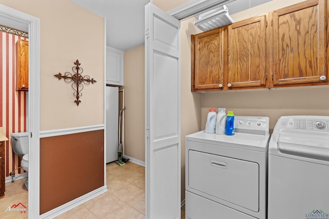 106 Brachfield Rd, Henderson, TX 75654 - laundry room with washer and dryer, cabinet space, and light tile patterned floors