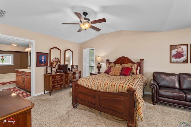 106 Brachfield Rd, Henderson, TX 75654 - bedroom with light carpet, lofted ceiling, multiple windows, baseboards, and ensuite bathroom