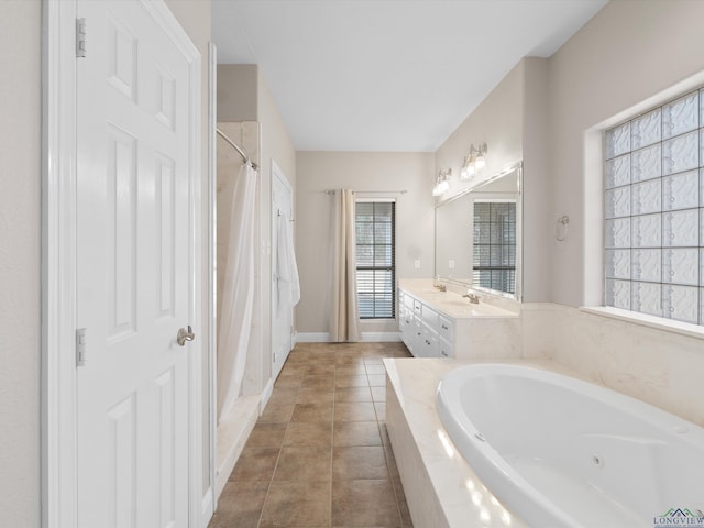 bathroom with tile patterned flooring, vanity, and separate shower and tub