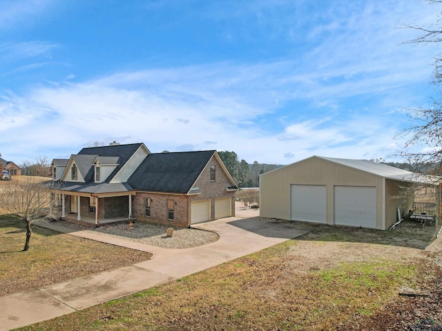 view of front of home with a garage, a front lawn, and covered porch