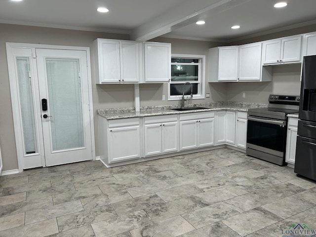 kitchen with white cabinets, refrigerator with ice dispenser, sink, and stainless steel range with electric cooktop