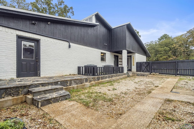 back of property featuring central air condition unit