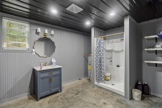 bathroom featuring concrete flooring, vanity, electric water heater, and curtained shower