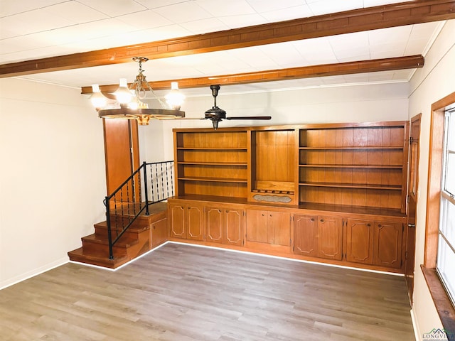 713 Martha Dr, Gladewater, TX 75647 - unfurnished living room with beam ceiling, light wood-type flooring, stairway, a chandelier, and baseboards