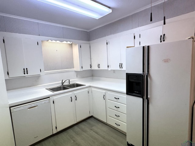 713 Martha Dr, Gladewater, TX 75647 - kitchen with white appliances, a sink, light wood finished floors, white cabinets, and light countertops