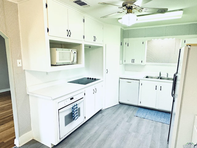 713 Martha Dr, Gladewater, TX 75647 - kitchen with white appliances, a sink, light wood-type flooring, a ceiling fan, and baseboards