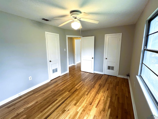 713 Martha Dr, Gladewater, TX 75647 - unfurnished bedroom featuring baseboards, wood finished floors, ceiling fan, and a closet