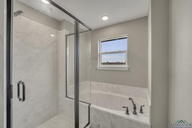 bathroom featuring separate shower and tub