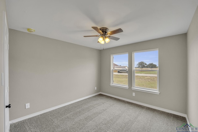 carpeted spare room featuring ceiling fan