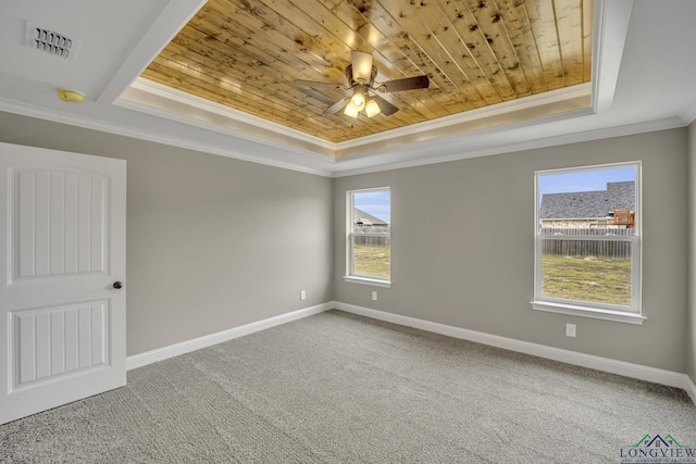 unfurnished room featuring carpet, ceiling fan, ornamental molding, a tray ceiling, and wood ceiling