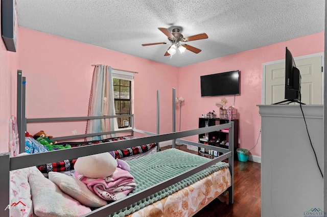 bedroom with baseboards, a ceiling fan, a textured ceiling, and wood finished floors