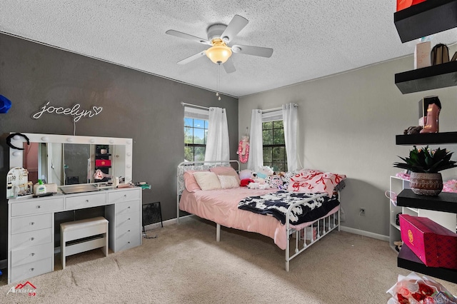 bedroom with carpet floors, a textured ceiling, and baseboards
