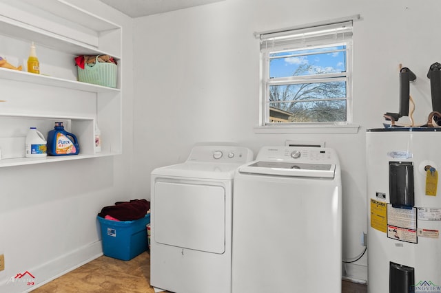 laundry area with laundry area, washer and dryer, and electric water heater