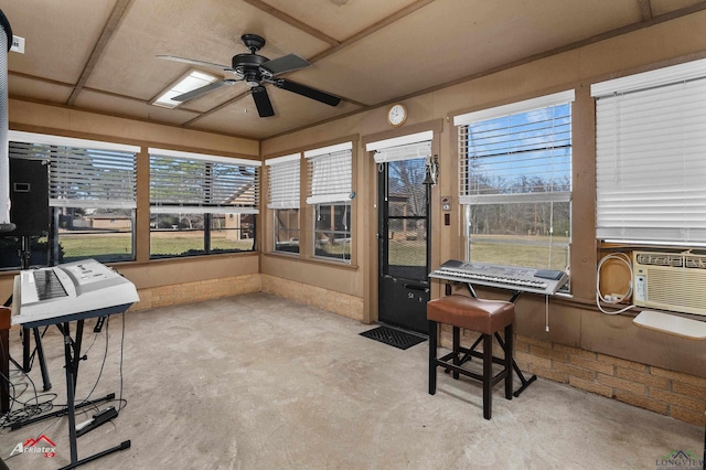 sunroom / solarium featuring cooling unit, a wealth of natural light, and a ceiling fan