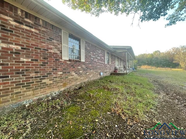 view of property exterior featuring brick siding