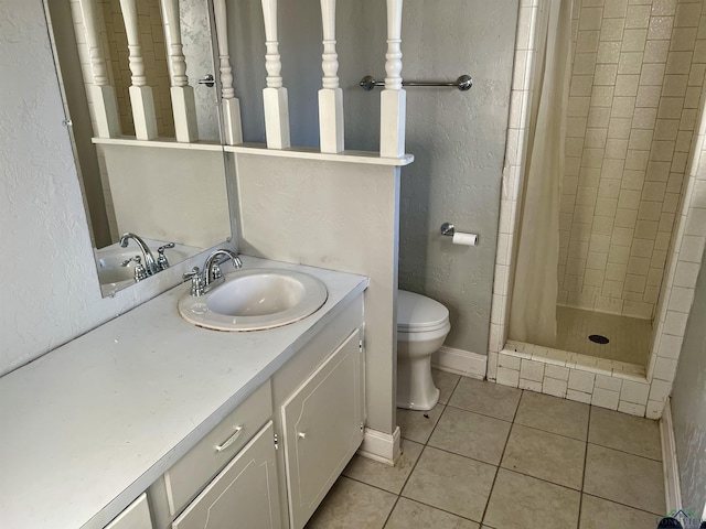 bathroom featuring tile patterned floors, toilet, vanity, and a shower with shower curtain