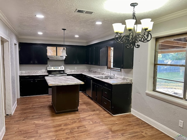 kitchen with sink, wood-type flooring, decorative light fixtures, a kitchen island, and stainless steel range with electric cooktop