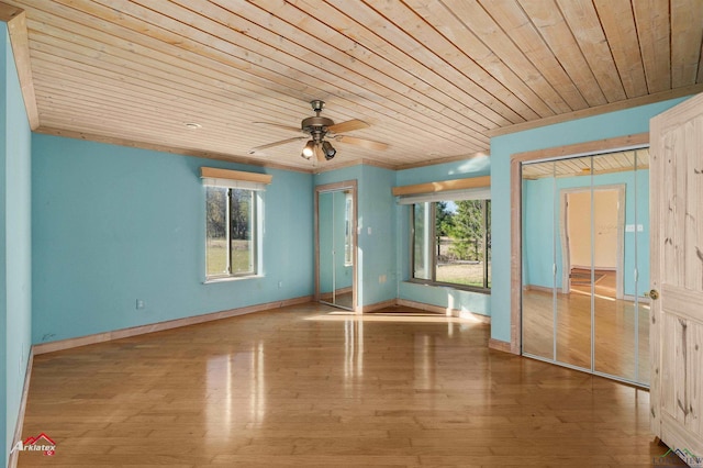 interior space featuring ceiling fan, ornamental molding, wooden ceiling, and wood-type flooring