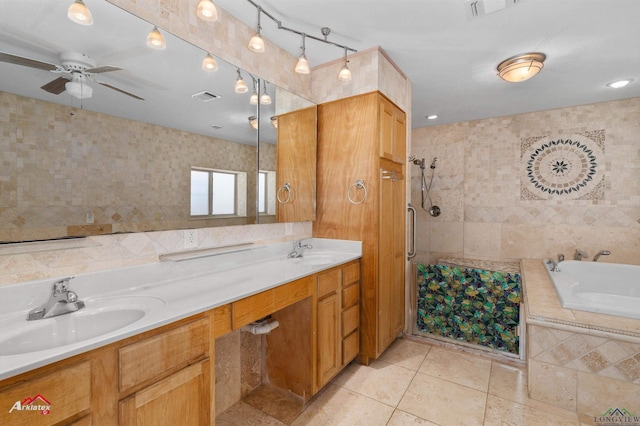 bathroom featuring vanity, ceiling fan, plus walk in shower, and tile walls