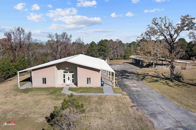 exterior space featuring an outdoor structure and a front lawn