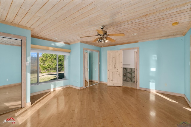 spare room with ceiling fan, wooden ceiling, and light hardwood / wood-style floors