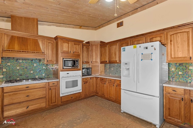 kitchen with wood ceiling, backsplash, appliances with stainless steel finishes, and vaulted ceiling