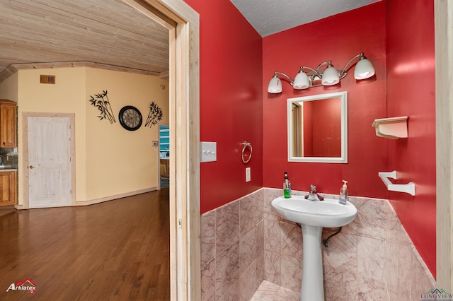 bathroom featuring hardwood / wood-style floors, a textured ceiling, and wood ceiling