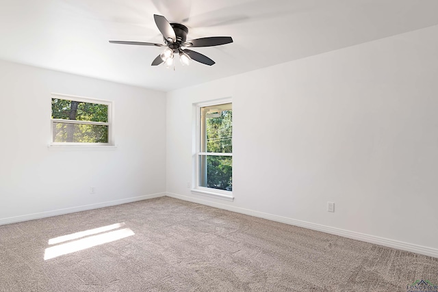 carpeted empty room featuring ceiling fan