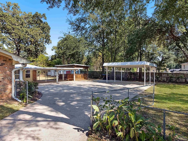 view of home's community featuring a yard and a carport