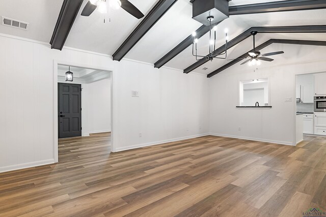 unfurnished living room with lofted ceiling with beams, wood-type flooring, and ceiling fan with notable chandelier