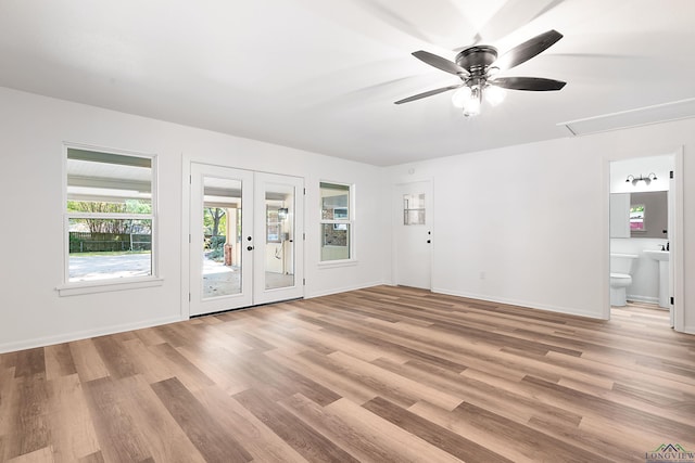 empty room with french doors, light hardwood / wood-style floors, and ceiling fan