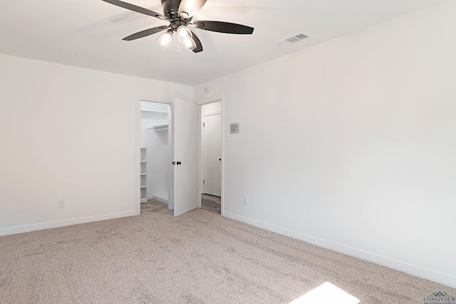 carpeted spare room with ceiling fan