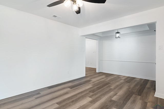 empty room with ceiling fan and dark hardwood / wood-style floors