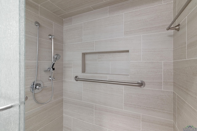 bathroom with a tile shower