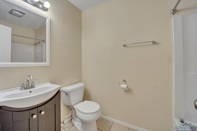 bathroom with a shower, tile patterned flooring, vanity, and toilet