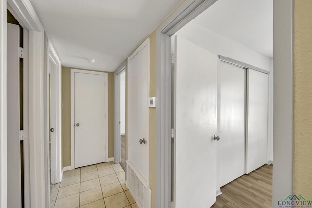 corridor with light tile patterned floors