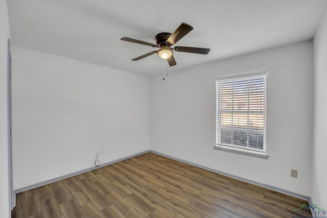 spare room with hardwood / wood-style flooring and ceiling fan