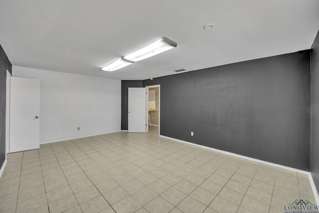 empty room with light tile patterned floors