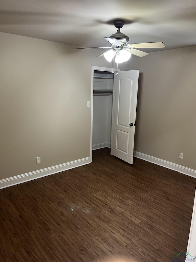 4101 Wesley St, Longview, TX 75604 - unfurnished bedroom featuring dark wood-type flooring, a ceiling fan, and a closet