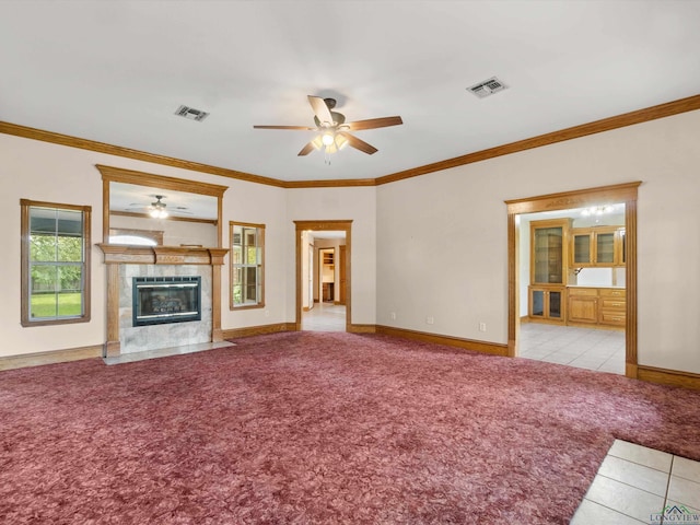 unfurnished living room featuring light carpet, a fireplace, and crown molding