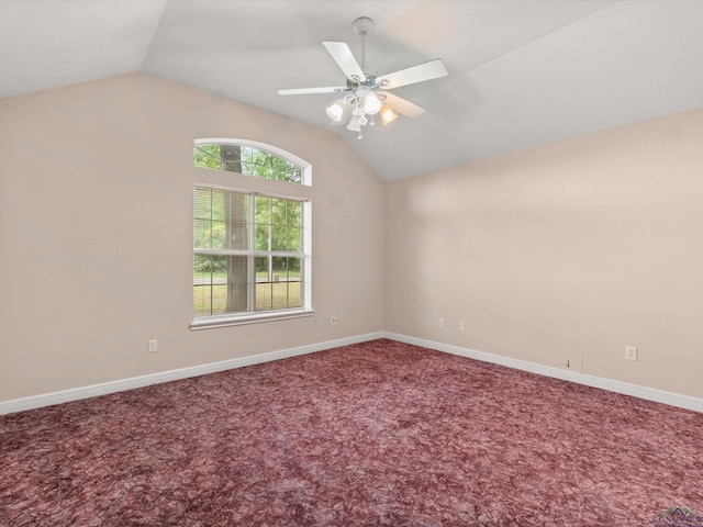 empty room featuring carpet, ceiling fan, and lofted ceiling