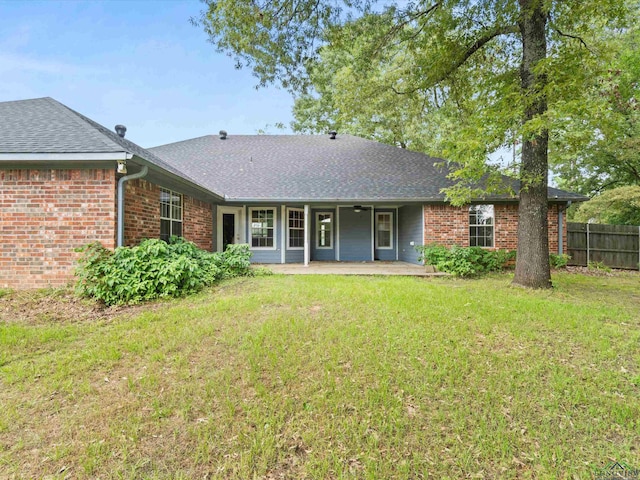 back of house with a patio area and a yard