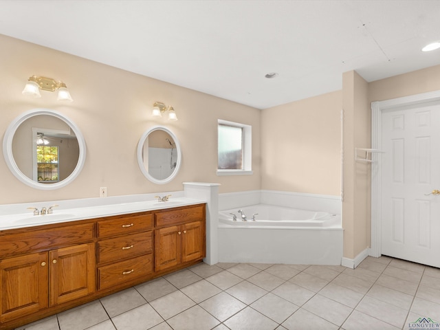 bathroom with tile patterned floors, a tub to relax in, and vanity