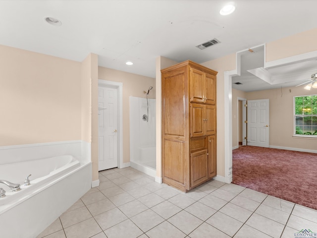 bathroom with tile patterned floors, ceiling fan, and plus walk in shower