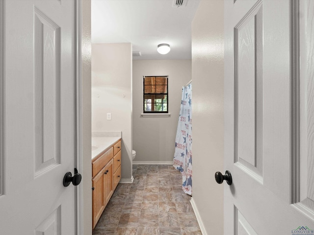 bathroom with vanity and toilet