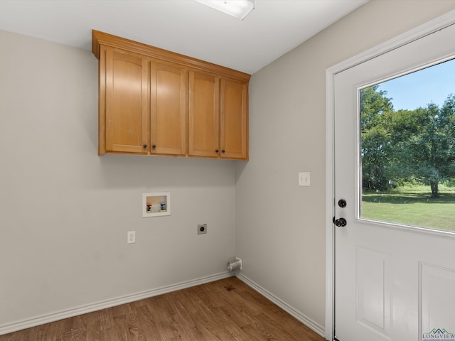 washroom featuring cabinets, hookup for a washing machine, a wealth of natural light, and electric dryer hookup