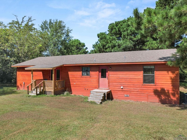 view of front of property with a front yard and central AC unit