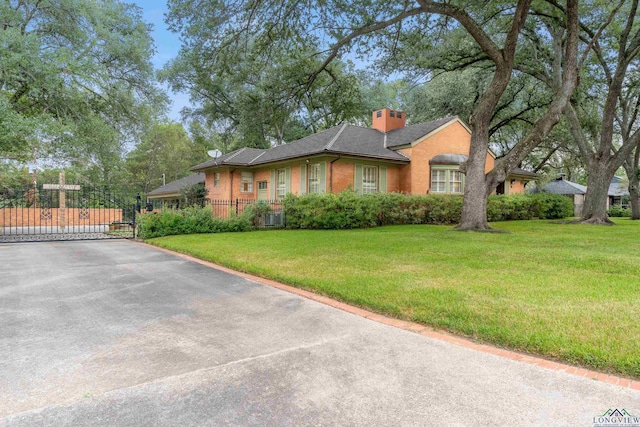 603 E Melton, Longview, TX 75602 - view of front of home featuring a gate, a chimney, brick siding, and central AC unit